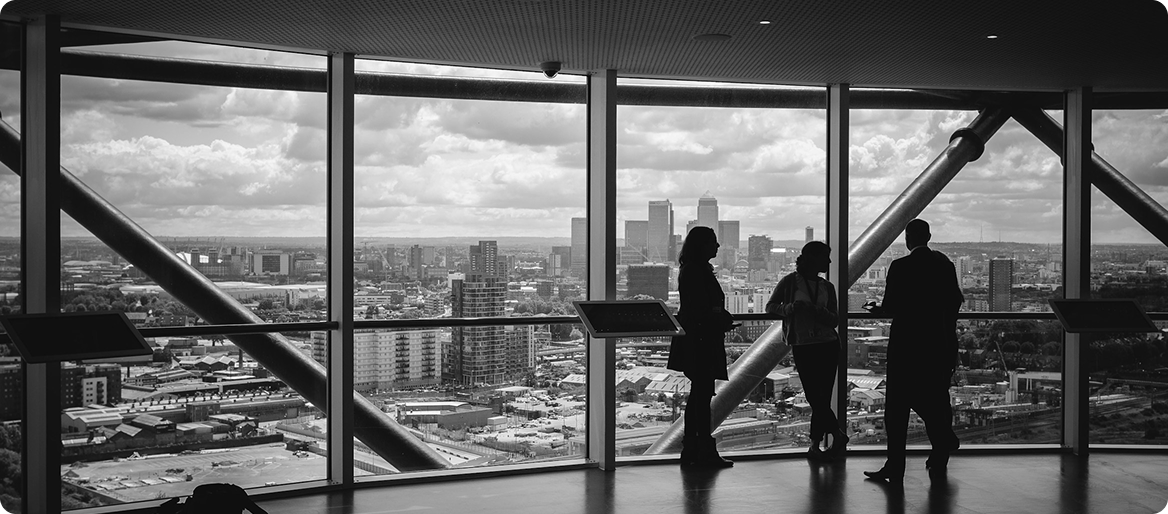 Business professionals overlooking global city skyline
