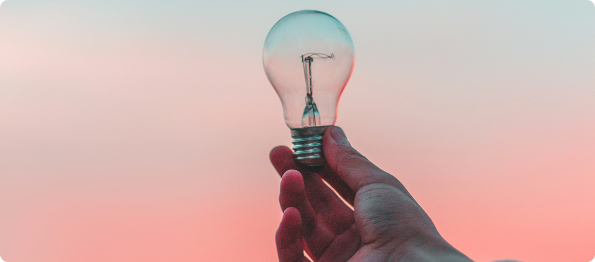 Hand holding a light bulb symbolizing innovation and patent ideas
