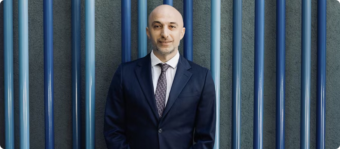 IP Agency professional in a navy suit against blue background